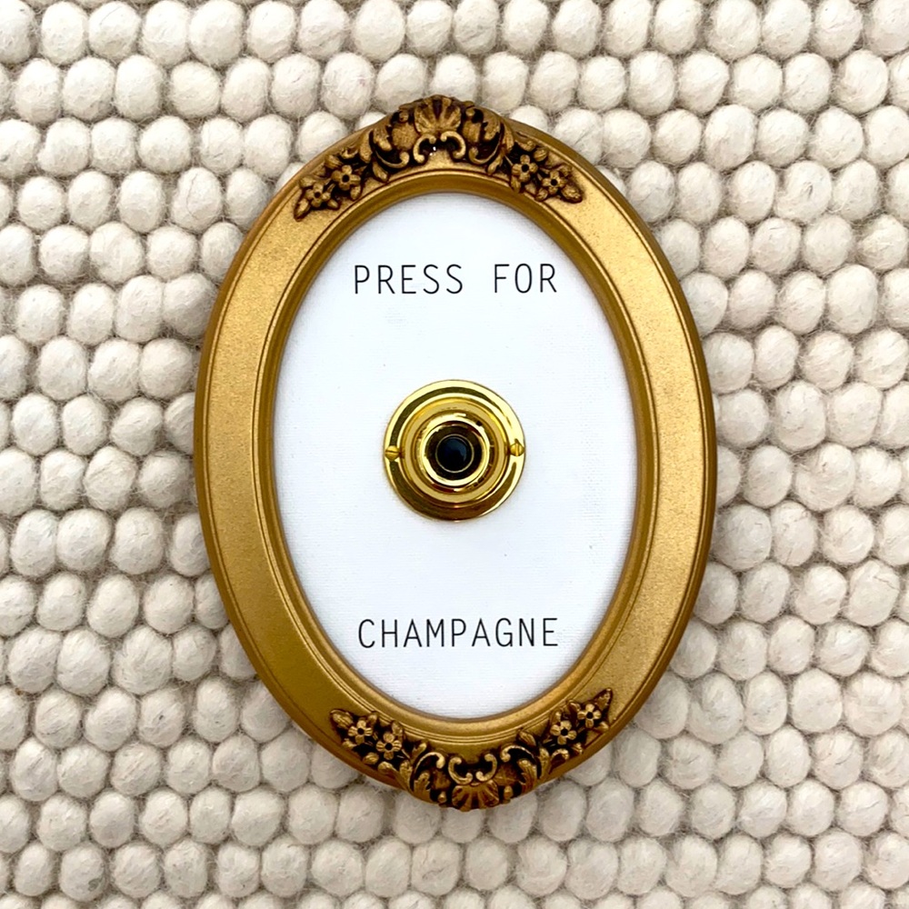 “Press for Champagne” wall sign